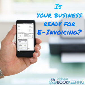 a hand holding a smartphone with a blurry desktop printer in the background. The words 'Is your Business Ready for E-Invoicing?' is overlaid beside the hand